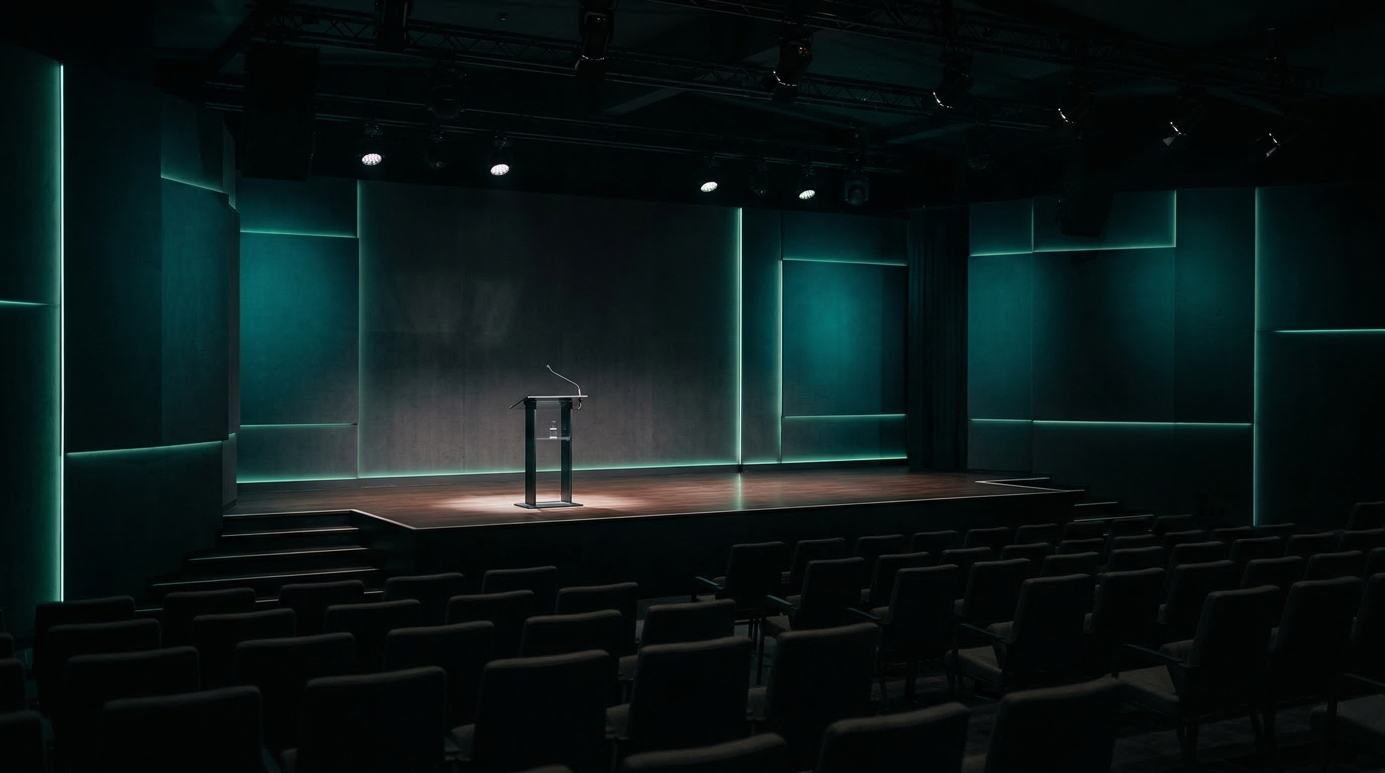 Modern conference stage with teal accent lighting